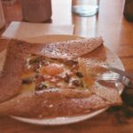a plate of food on a wooden table