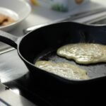 a frying pan filled with food on top of a stove