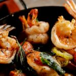 Cooked shrimp and vegetables in a pan