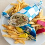 A plate of french fries and a wrapper