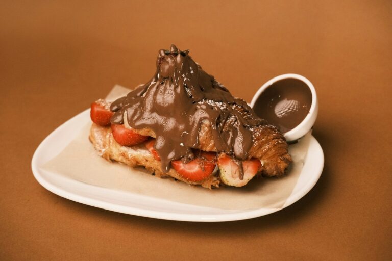 A piece of chocolate dessert on a plate with a spoon