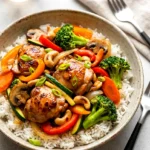 Chicken stir-fry with glossy honey-soy sauce, broccoli, peppers, carrots, and chicken served over rice