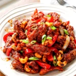 Spicy Dragon Chicken served with crispy chicken, bell peppers, onions, and cashews in glossy sauce