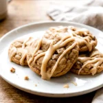 Maple brown sugar cookies with maple icing stacked on a plate