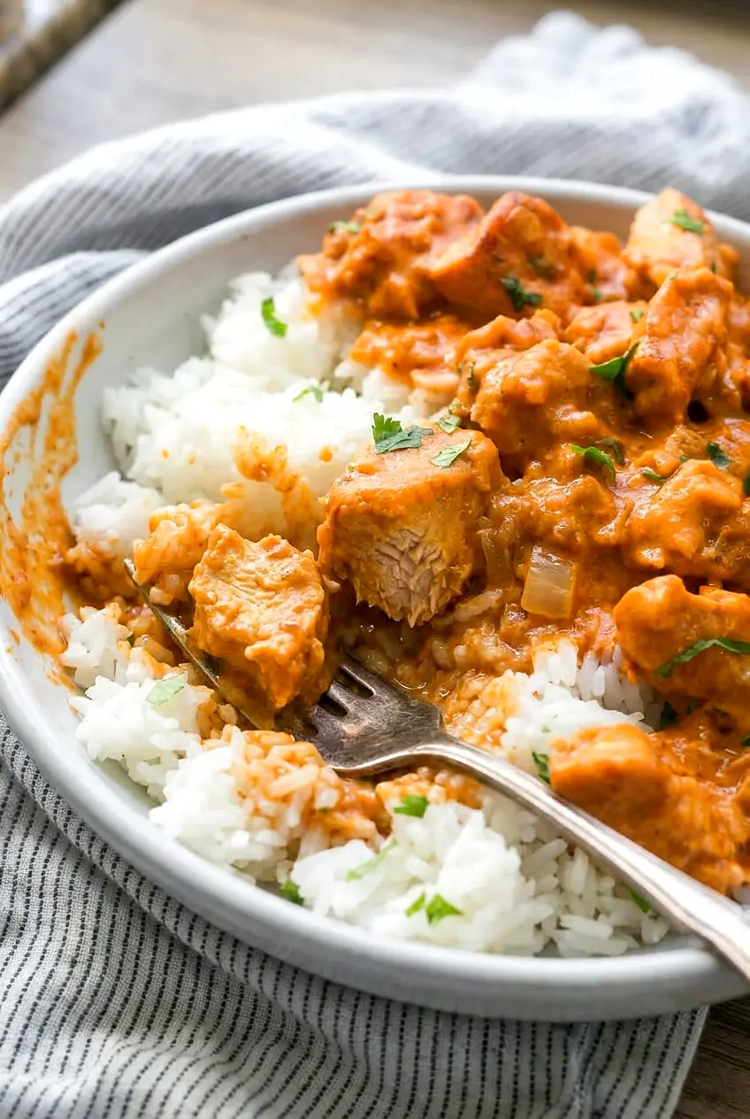 Close-up of coconut chicken rice bowl showing tender chicken and saucy rice