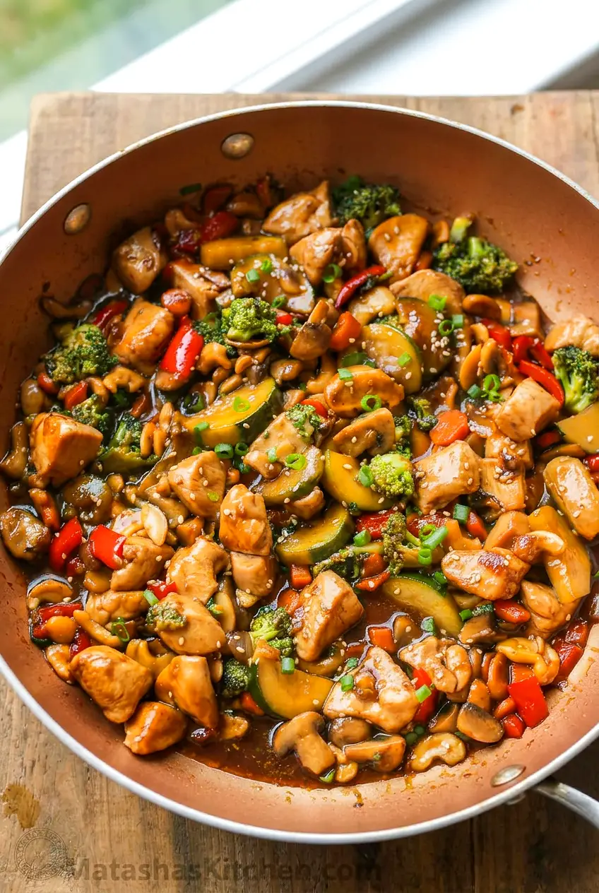 Close-up of chicken stir-fry with glossy honey-soy sauce coating the vegetables and chicken