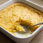 Creamy 5-ingredient corn casserole with whole kernels in a white ceramic baking dish