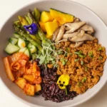 Anti-Inflammatory Harvest Glow Bowl with black rice, chickpea crumble, squash, asparagus, mushrooms, cucumber, and kimchi.