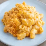 Loose serving of baked vegan mac and cheese with creamy elbows and a golden breadcrumb topping