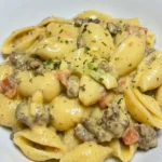 Crock Pot Rotel Pasta with beef crumbles and intact shells coated in golden cheese sauce