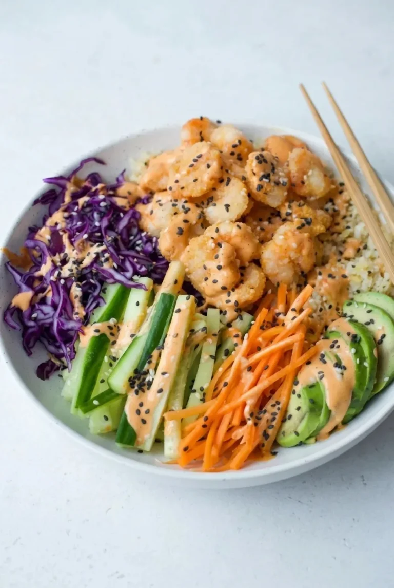 Crispy shrimp sushi bowl with avocado, cucumber, carrot, purple cabbage, spicy mayo, sesame, and white rice