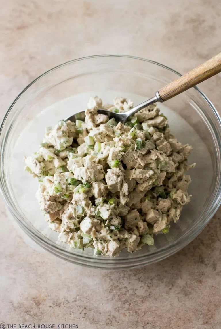 Classic Creamy Chicken Salad in 15 Minutes Classic creamy chicken salad with celery and scallions in a clear glass bowl