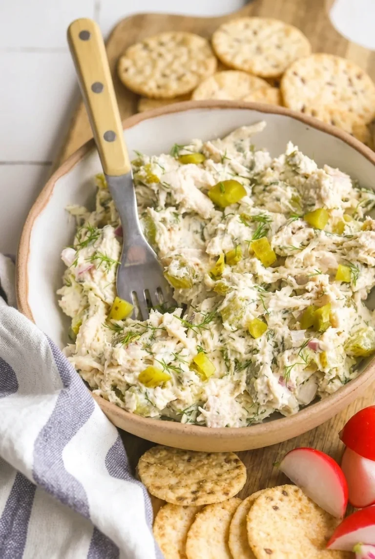 Creamy Dill Pickle Chicken Salad with Greek Yogurt Creamy dill pickle chicken salad with shredded chicken, pickle chunks, and fresh dill in a ceramic bowl with crackers and radishes
