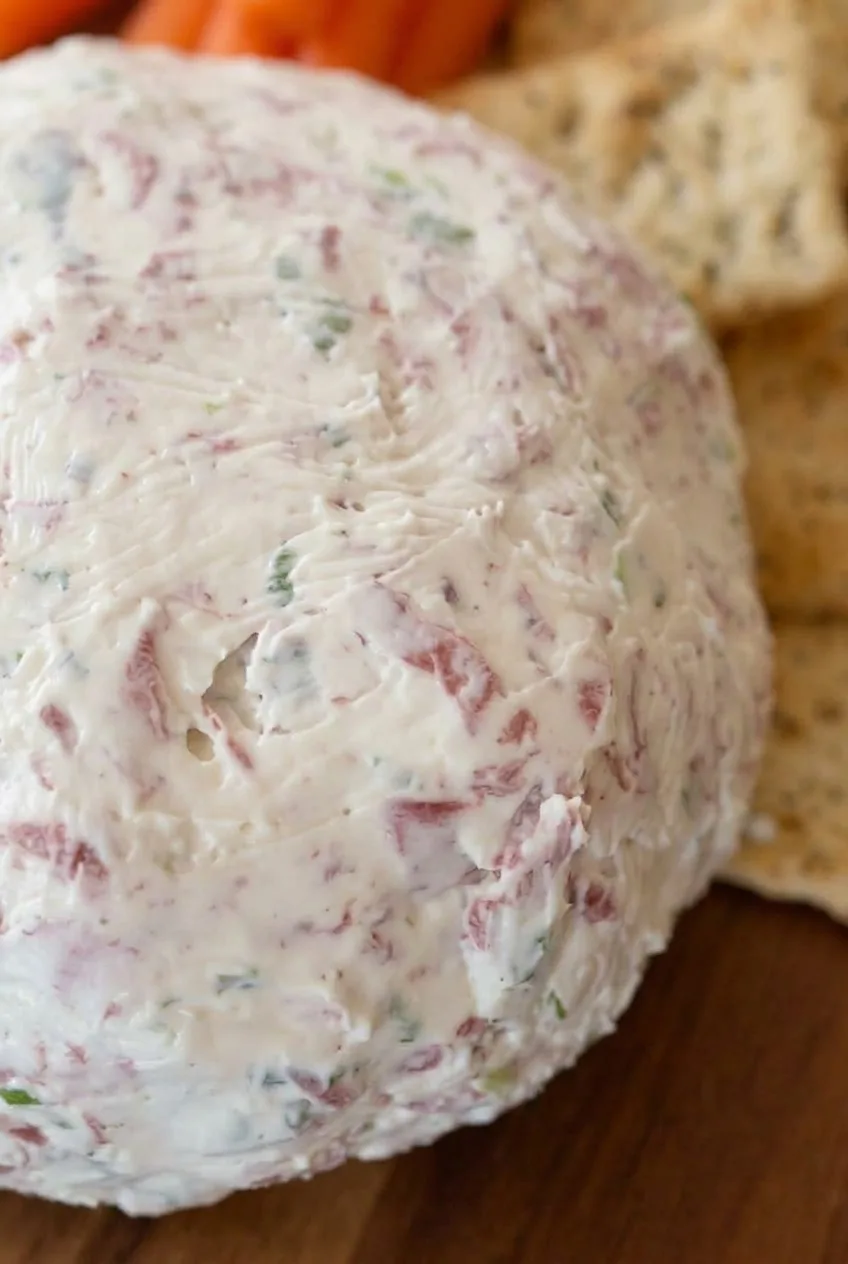 Close view of creamy cheese ball surface flecked with dried beef and green onion