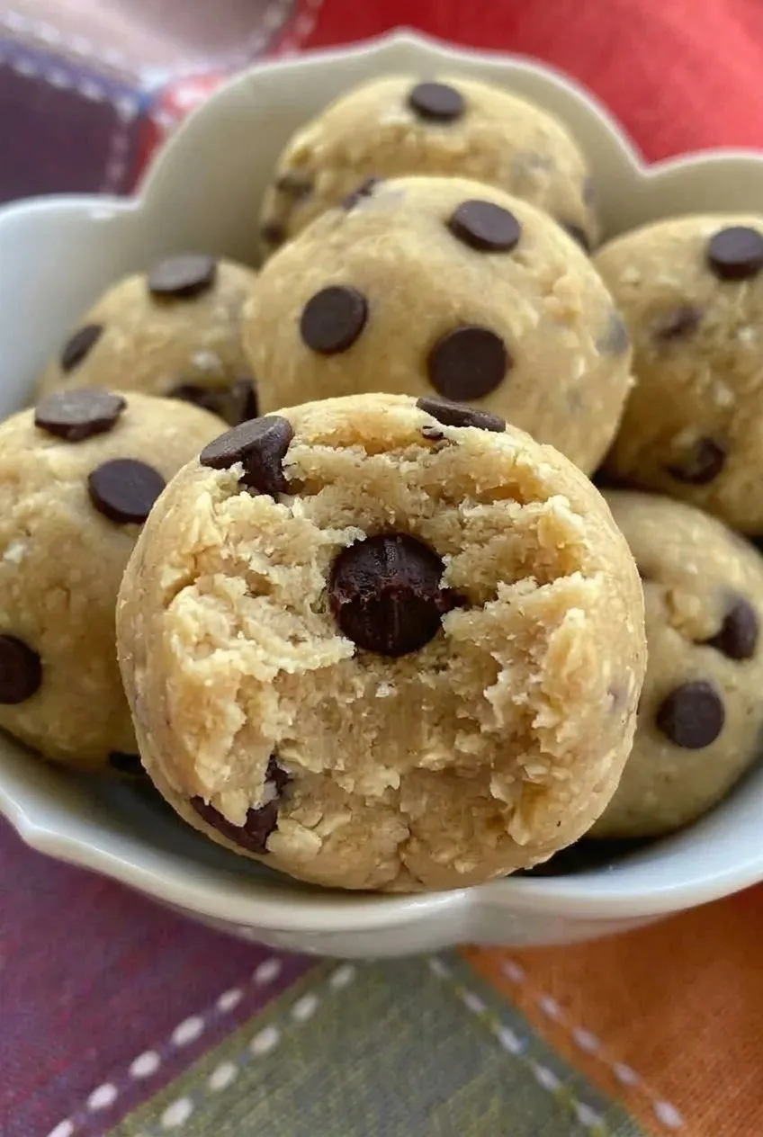 Broken-open chickpea cookie dough bite showing its soft center and intact chocolate chips