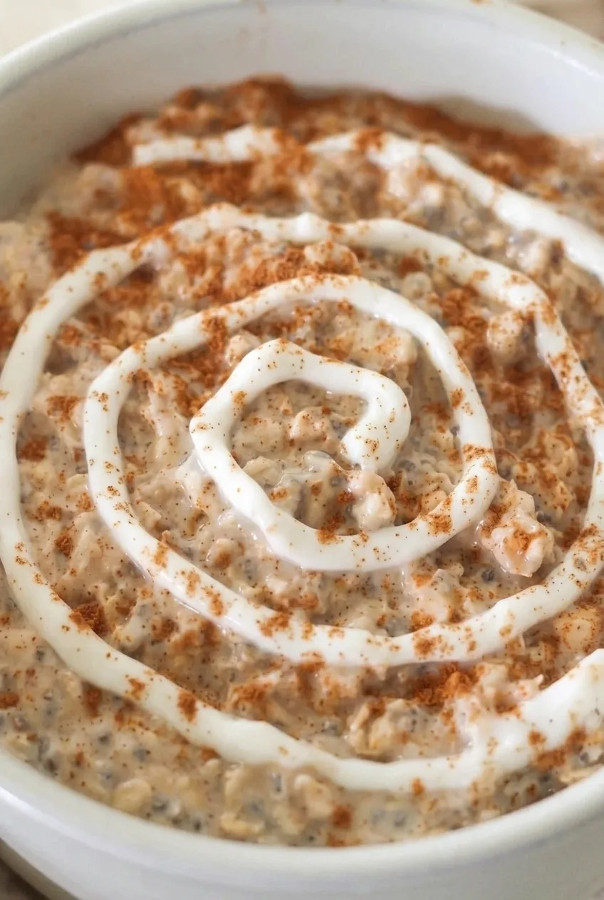 Close view of textured cinnamon oats, chia flecks, and a raised Greek yogurt spiral