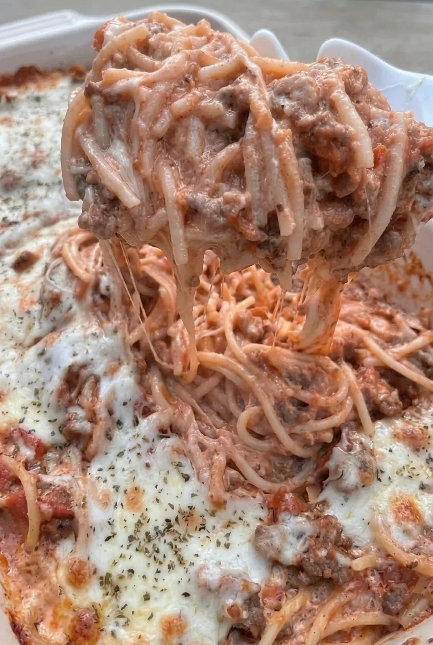 Close detail of creamy spaghetti, ground beef, and stretchy melted cheese in Million Dollar Spaghetti Casserole.