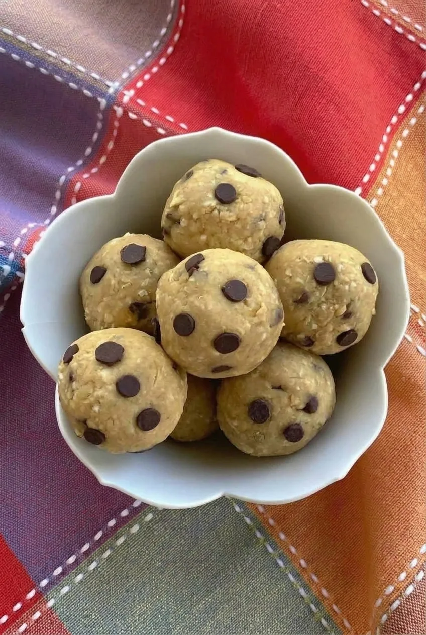Full bowl of chickpea cookie dough bites on colorful patterned fabric